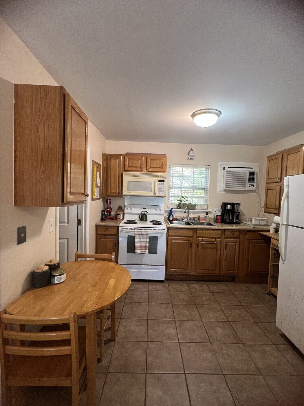 Cabin kitchen with stove, fridge, and dining table