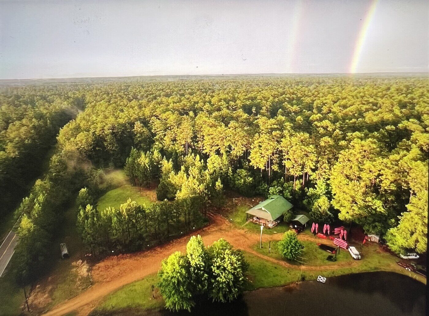 Aerial view of DeSoto Outfitters with rainbow over the DeSoto National Forest